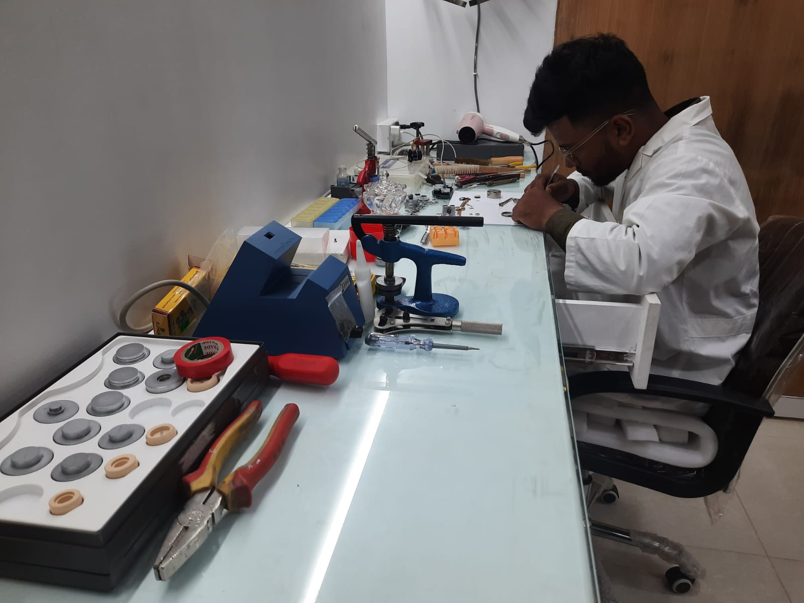 A watch movement being assembled by a watchmaker.